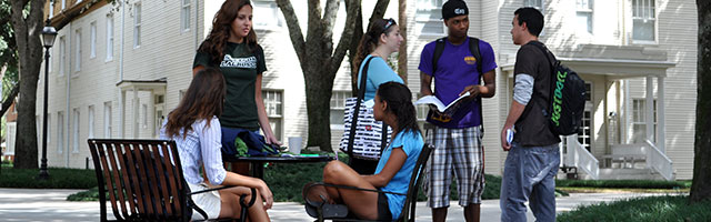 students around table enjoying time outside with peers