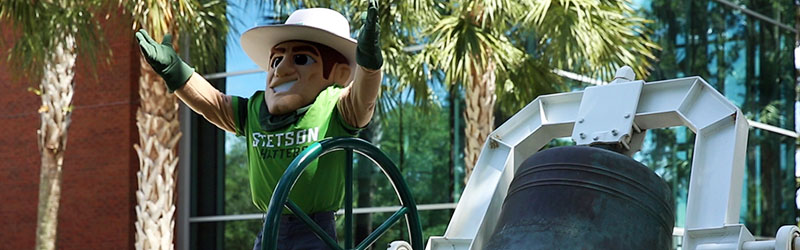 John B mascot celebrating with giant green bell