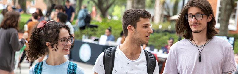 three student swalking together on campus