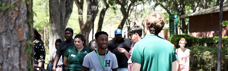 students receiving a tour from ambassador around campus