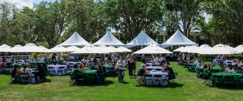 tables and people in the stetson green during event