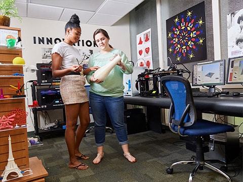 two girls talking in the innovation lab