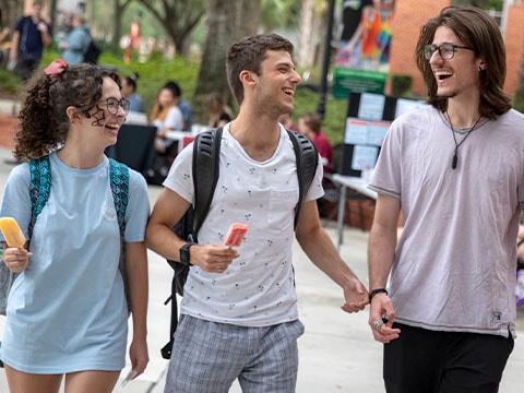 three students eating ice cream outside