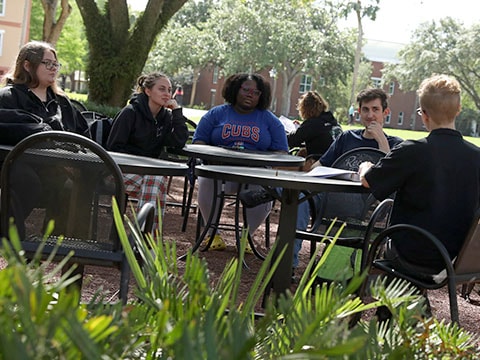 students sitting and talking outside