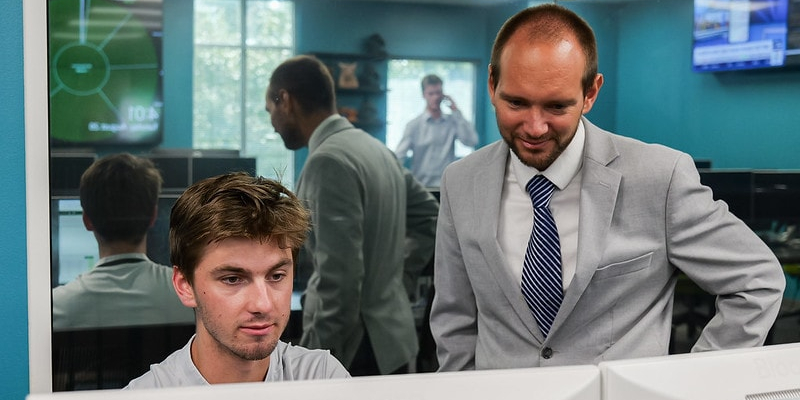 business professor and student looking at computer