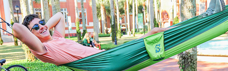 student lying down in a hammock