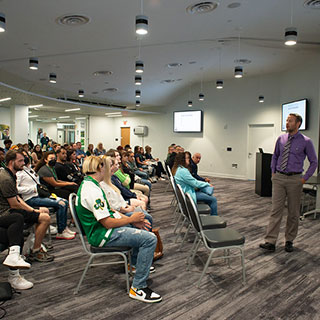 A staff member doing a presentation for prospective student families