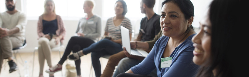 Graduate students sitting in a circle chatting