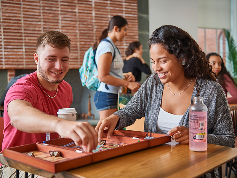 Students playing a board game in a common area