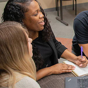 A Stetson University graduate group student group working together in the the Lynn Business Center