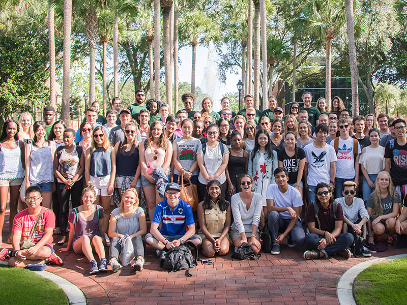 group of premier scholarship program students posing in palm court