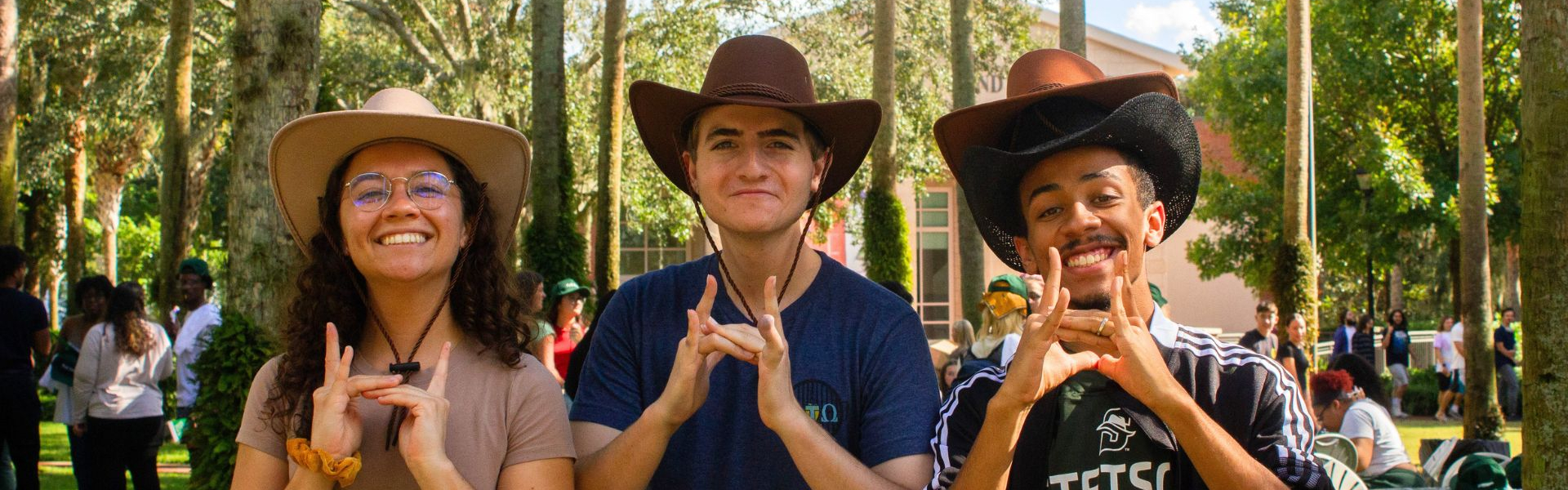 students with stetson hats taking pictures together