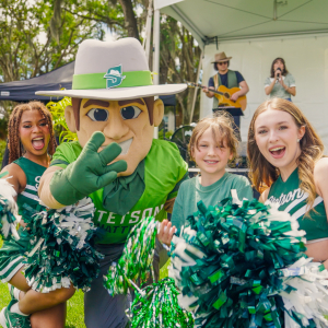 stetson mascot john b stetson and cheerleaders with members of the community