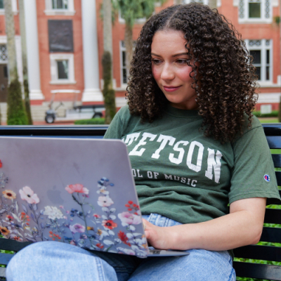 student using laptop outside