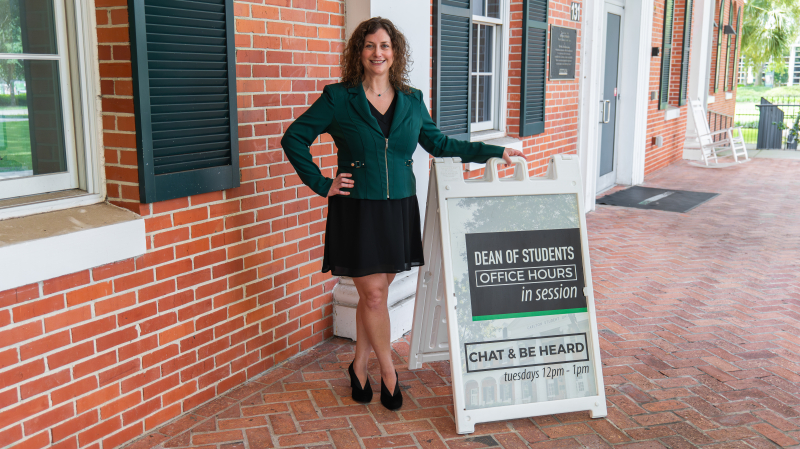 Lynn Schoenberg by Dean of Students sign