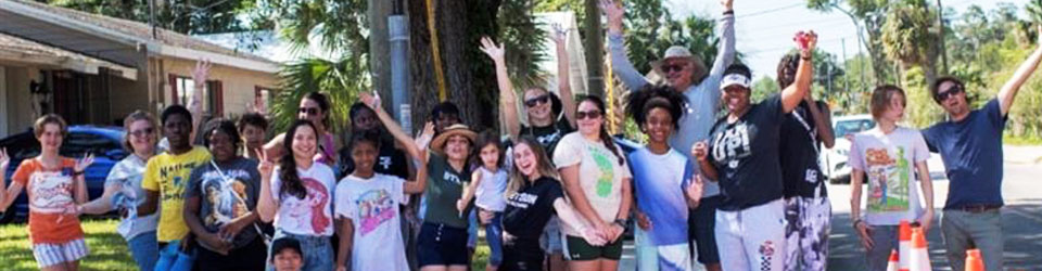 people from the community smiling after finishing a mural