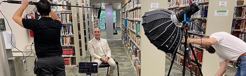 A professor being interviewed at the library.