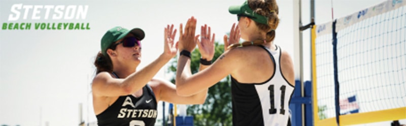 Women's Beach Volleyball, two students celebrating during game