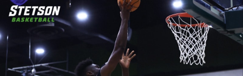 student from Men's Basketball about to score