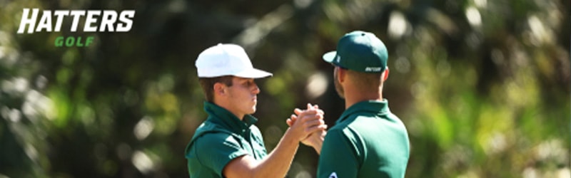 two members from Men's Golf sahing hands in celebration