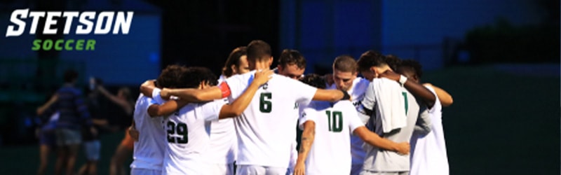 Men's Soccer team group hugging before game