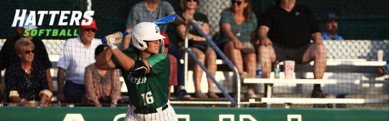 Girl from softball team batting during game