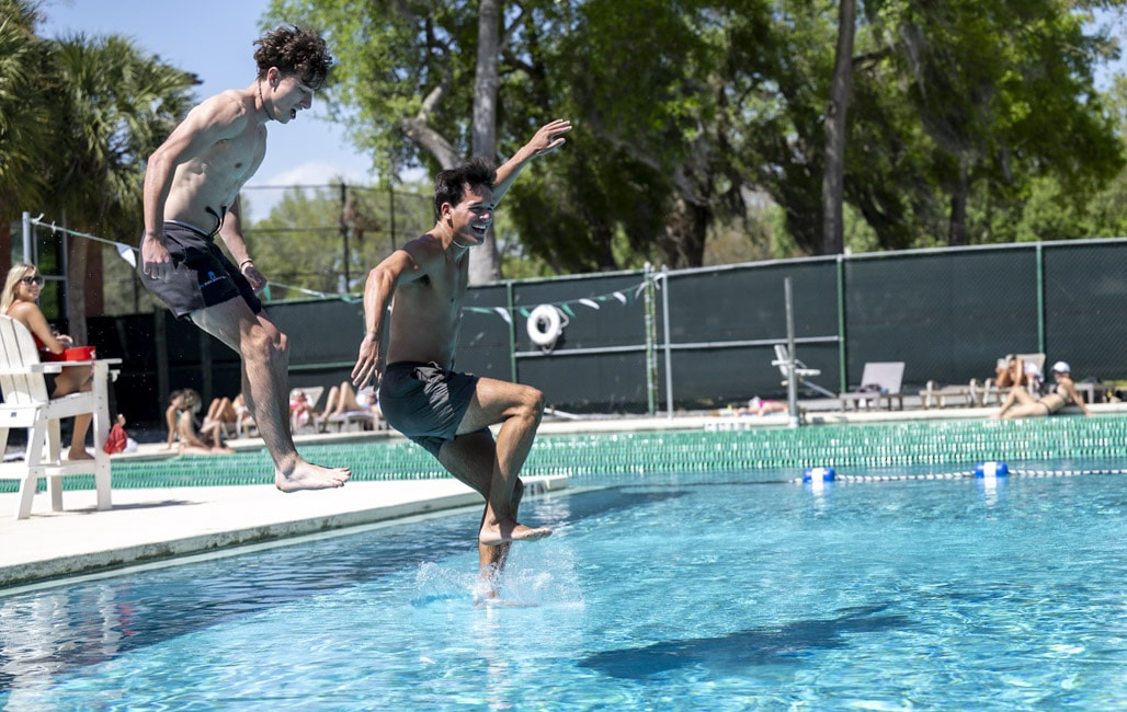 two guys jumping in the pool