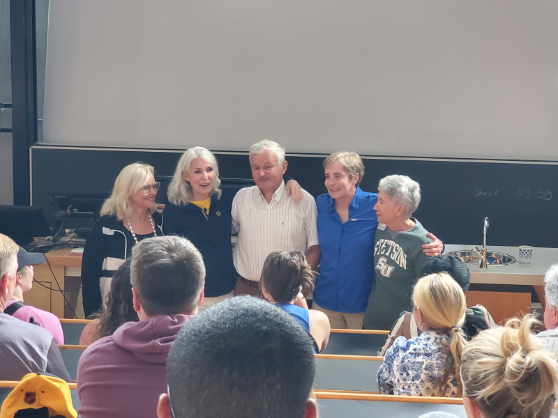 people from documentary standing close together in classroom in front of an audience