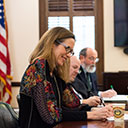 Person signing document at a desk