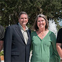 2 Donors smiling in a group photo in front of Stetsons Fountain