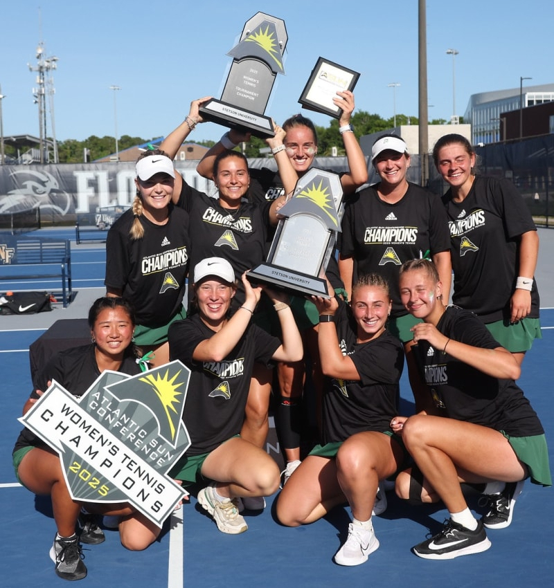 volleyball team group holding trophy