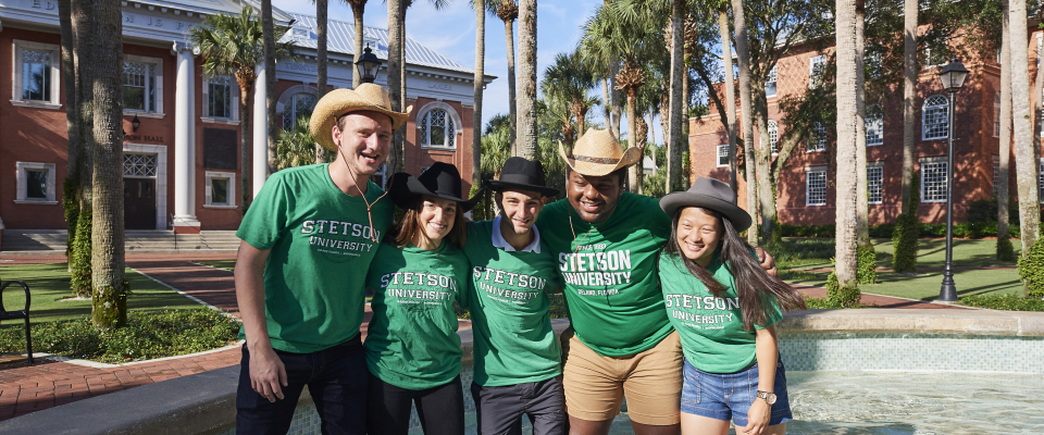 students in the fountain wearing stetson shirts
