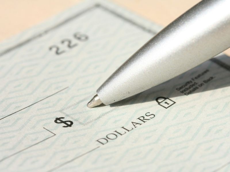 person filling out a physical check