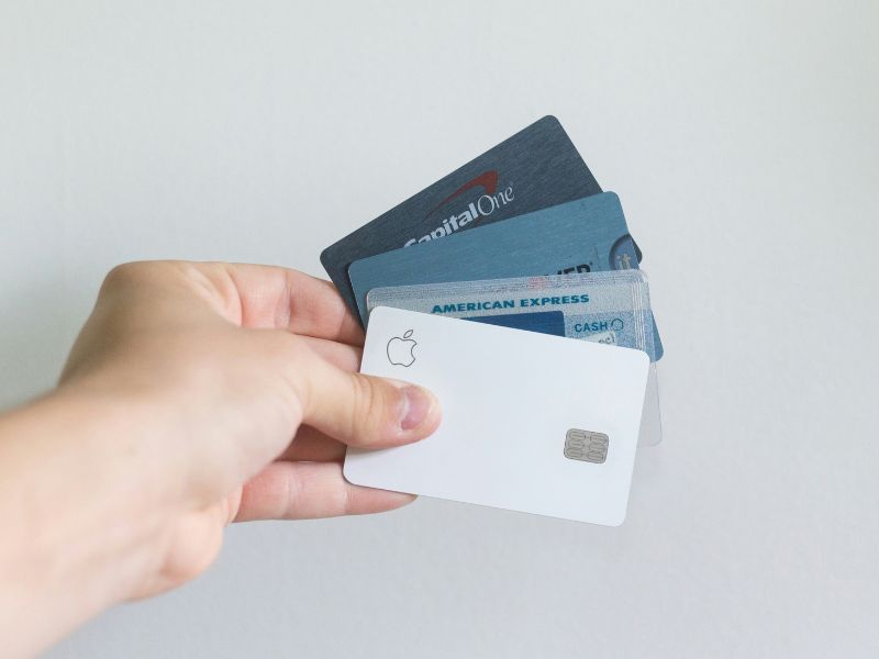 a hand holding a black credit card