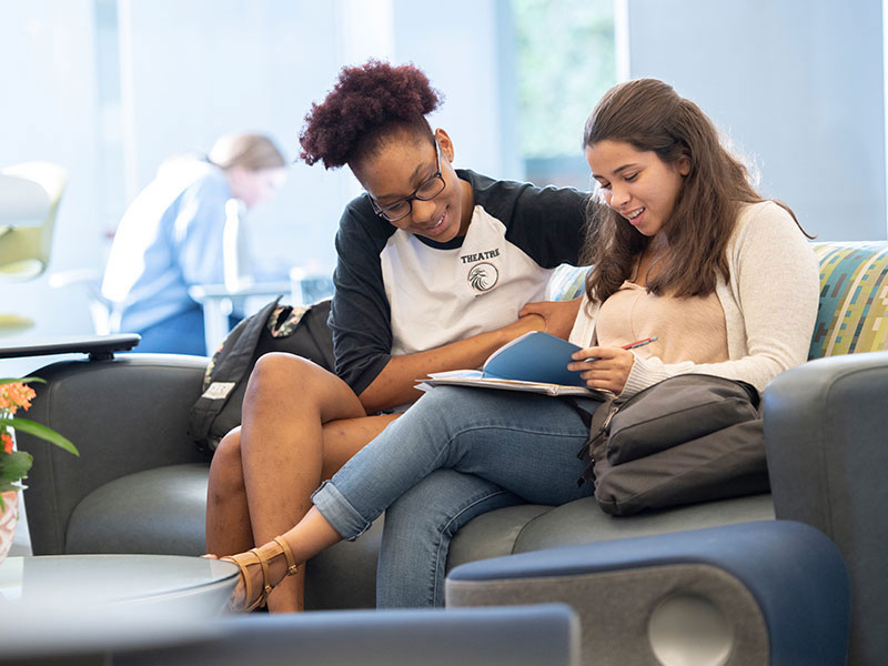 two students reviewing notes together