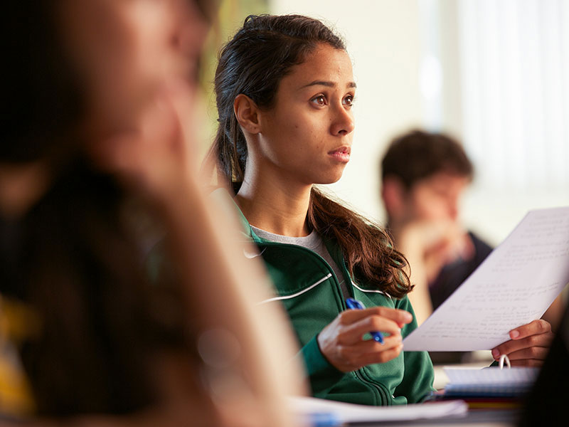 a student taking notes in class