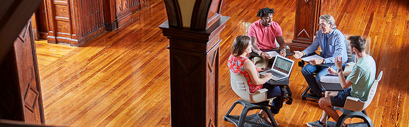 Students talking to a professor in Elizabeth Hall.