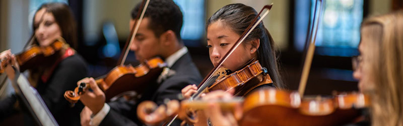 Stetson University music students playing stringed instruments at a concert.