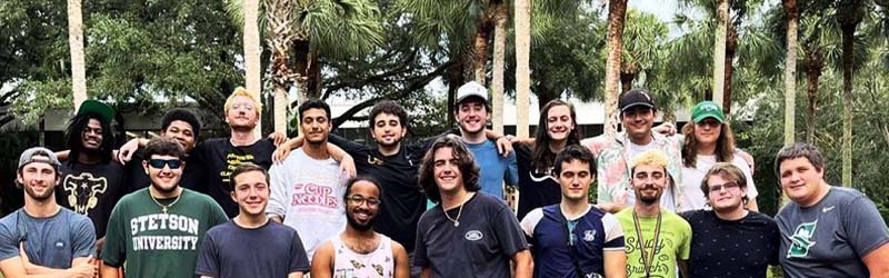 group of guys from greek organizations standing in front of the fountain