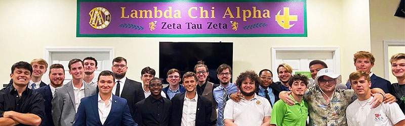 students from fraternity posing and smiling together