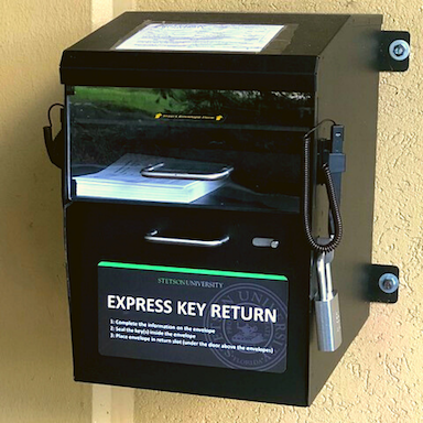 media/dropbox.png Black DROPBOX outside of the front entrance of our office at University Hall
