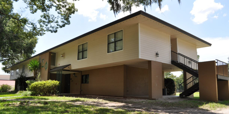 The brown paint and brick exterior of one of the houses