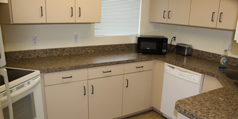 Kitchen of a house, with a microwave, oven, stove, dishwasher, sink and fridge