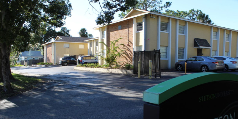 The yellow and white paint exterior of Stetson Cove Apartments