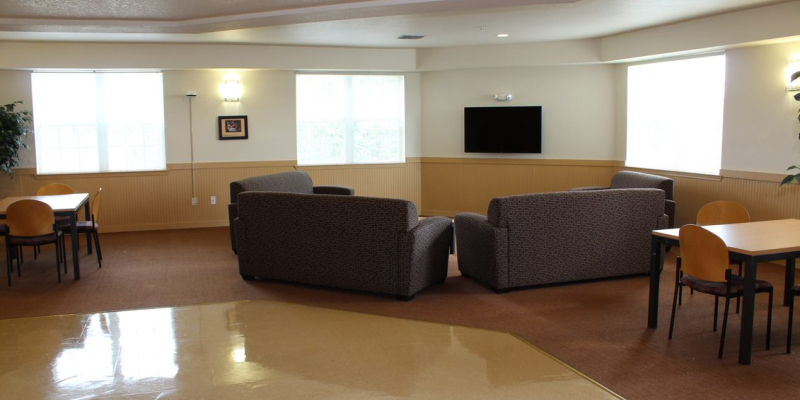 Lounge of Hatter Hall, with TV, sofas, tables and chairs