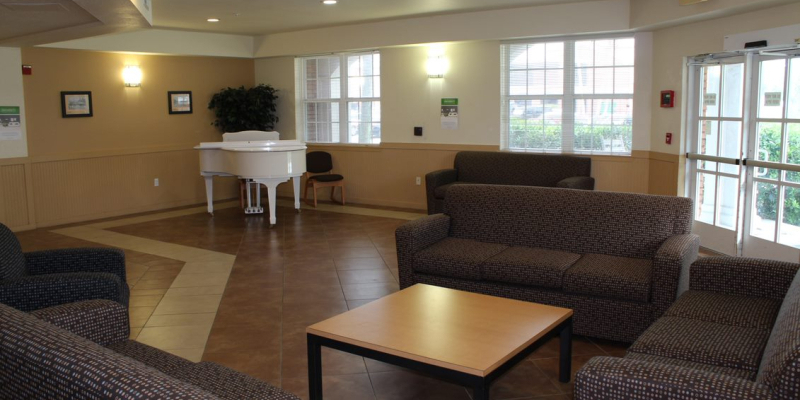 Lobby of Hatter Hall, with sofas, table and piano