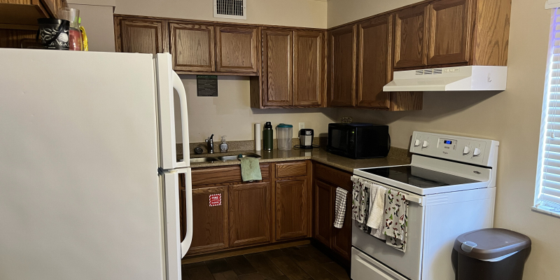Kitchen with stove and oven, refrigerator, cabinets and sink