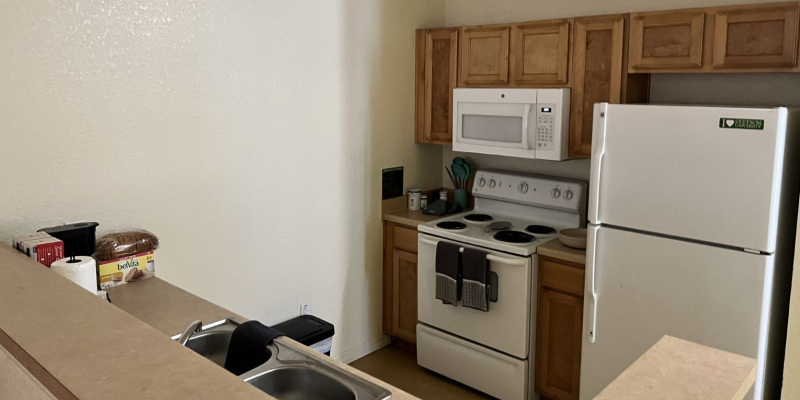 Kitchen with stove and refrigerator in 4 bedroom UVA apartment