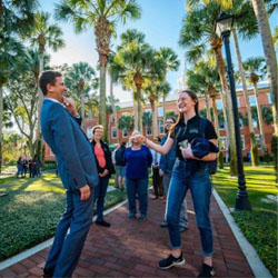 president talking with studnets outside in palm court