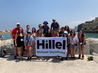 Stetson students smiling on the beach of Tel Aviv